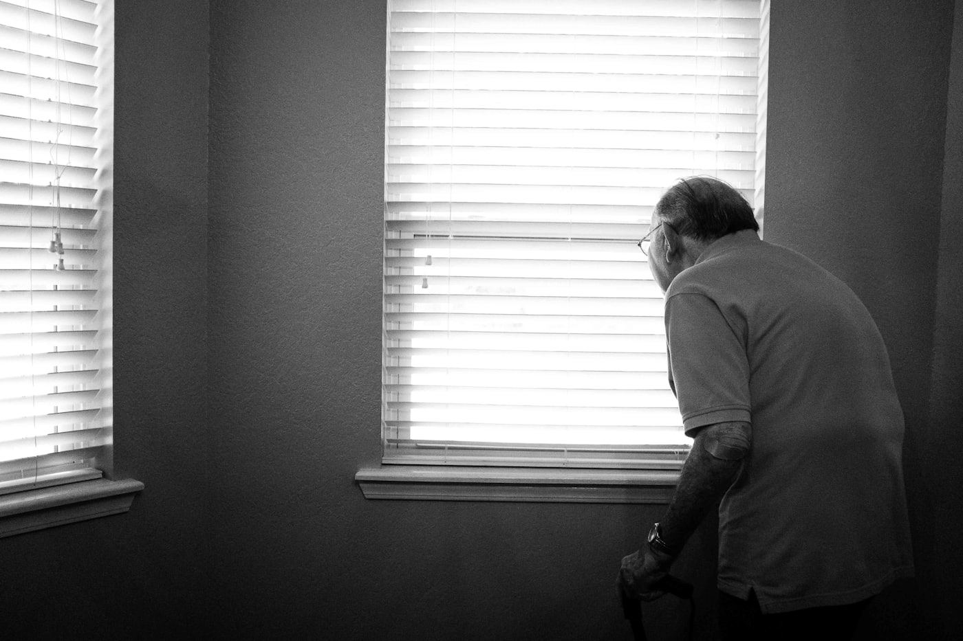 A person gazing toward a window, lost in thought