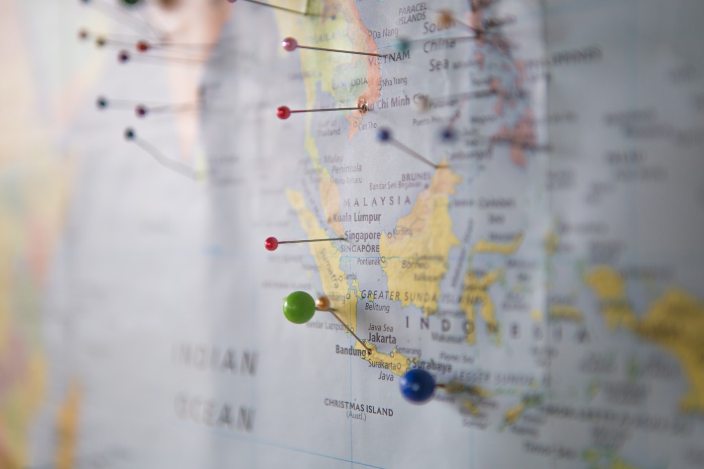 A world map marked with travel pins