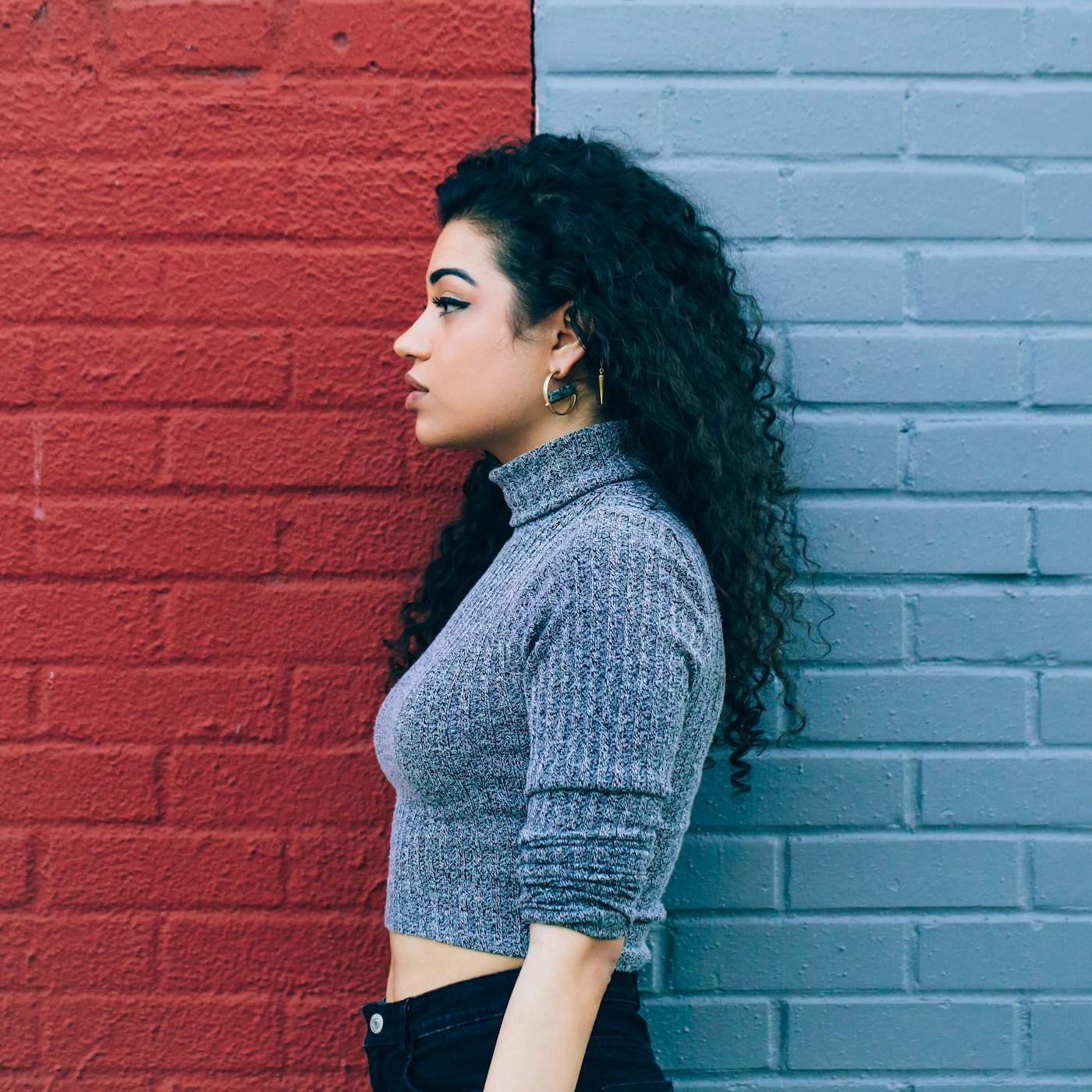 A person standing between two contrasting painted walls