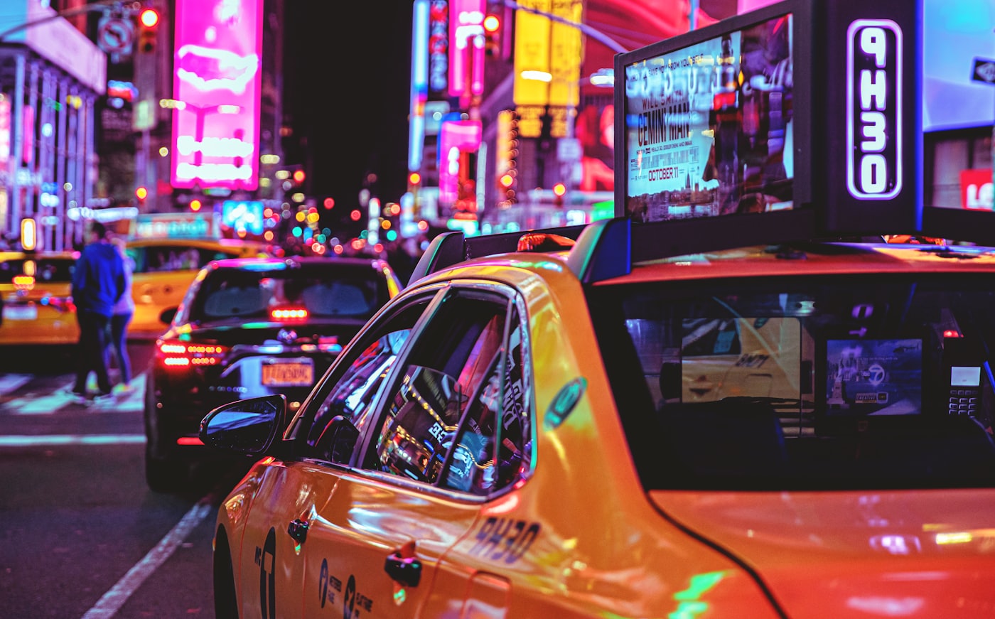 Yellow taxi cab on a city street at night