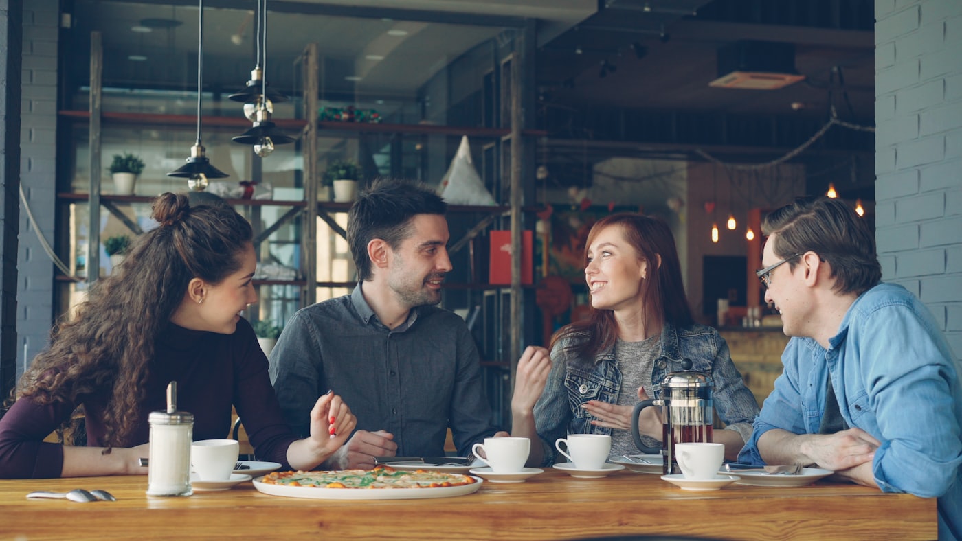 Friends in warm conversation over coffee